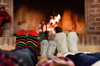 Family relaxing near fireplace - call IDC Heating and Cooling for great Furnace repair in Plymouth